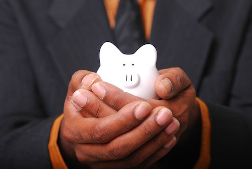 A person holding a piggy bank in his hand